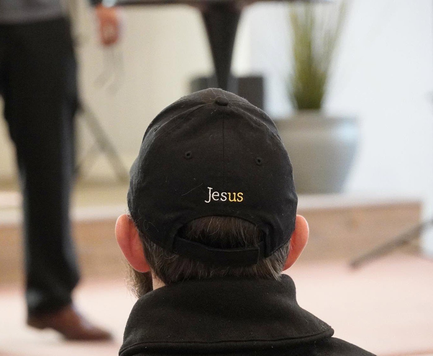 Church member in a Jesus cap listening to the sermon at Grace Words Bible Church